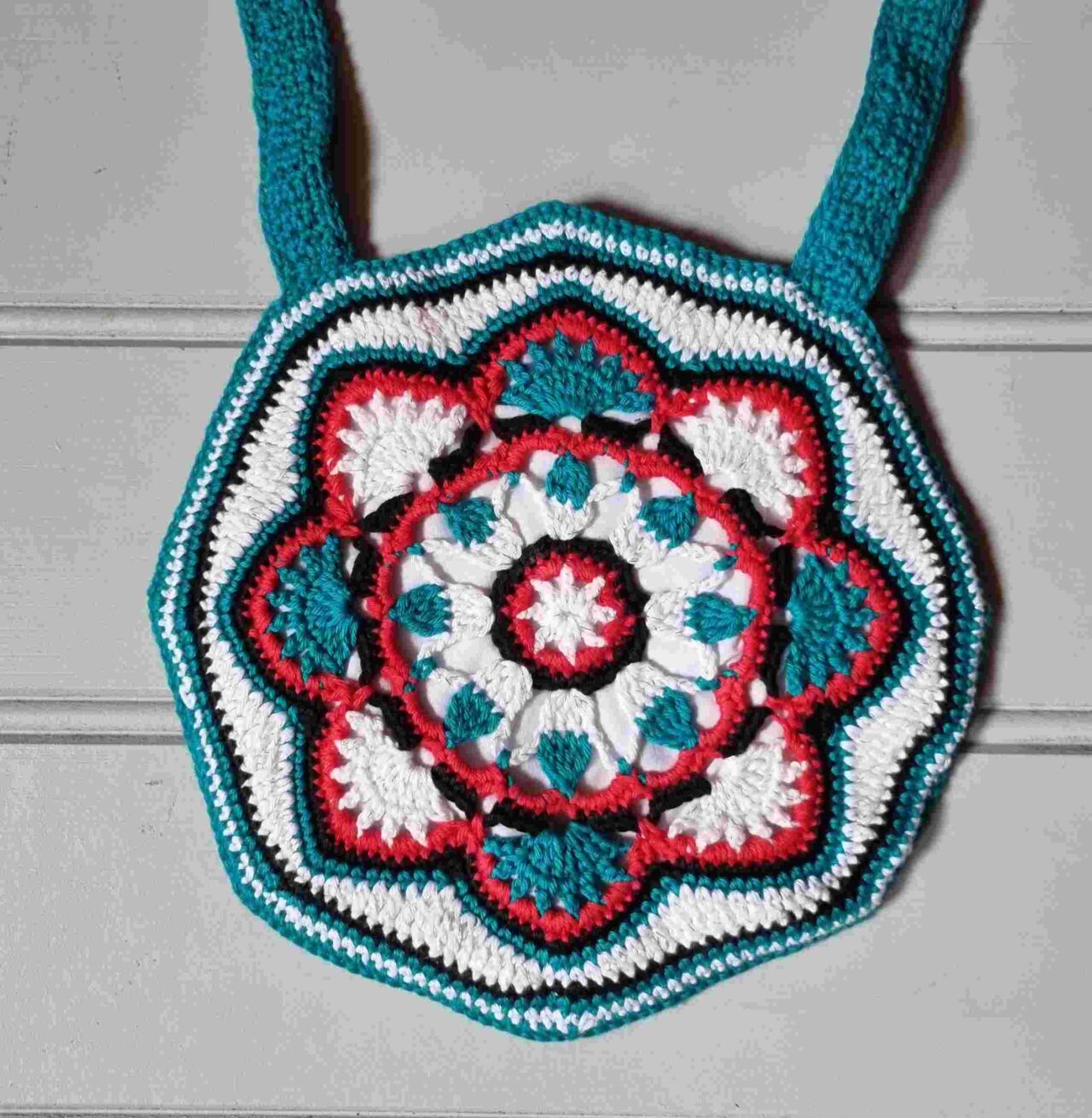 Handcrafted crochet shoulder bag by Ingerlise turquoise, red and