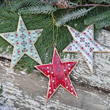 Set of three tin Alpine folk art red, sage and white Scandi stars by Gisela Graham