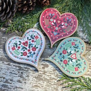 Set of three wooden Alpine folk art mint green, red and white Scandi Christmas hearts by Gisela Graham